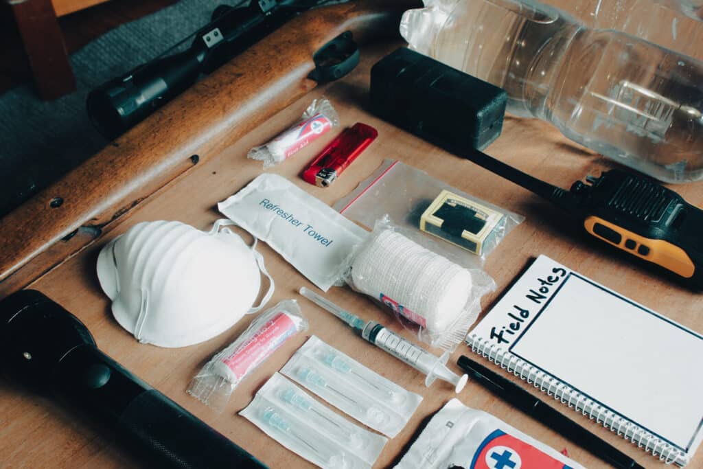 Travel first aid kit essentials displayed on table.