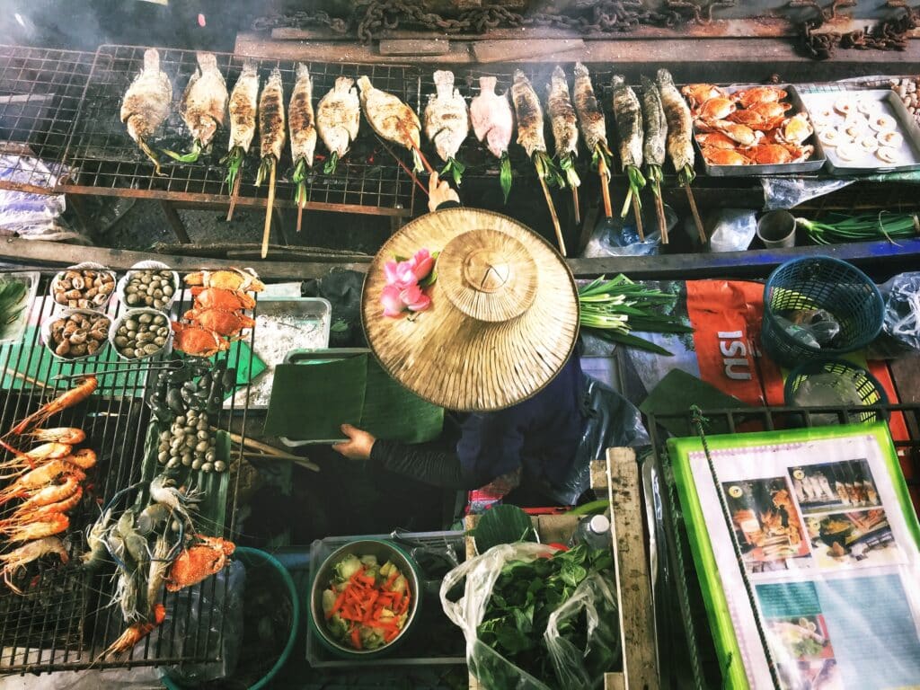 Thai food vendor selling in a floating market.