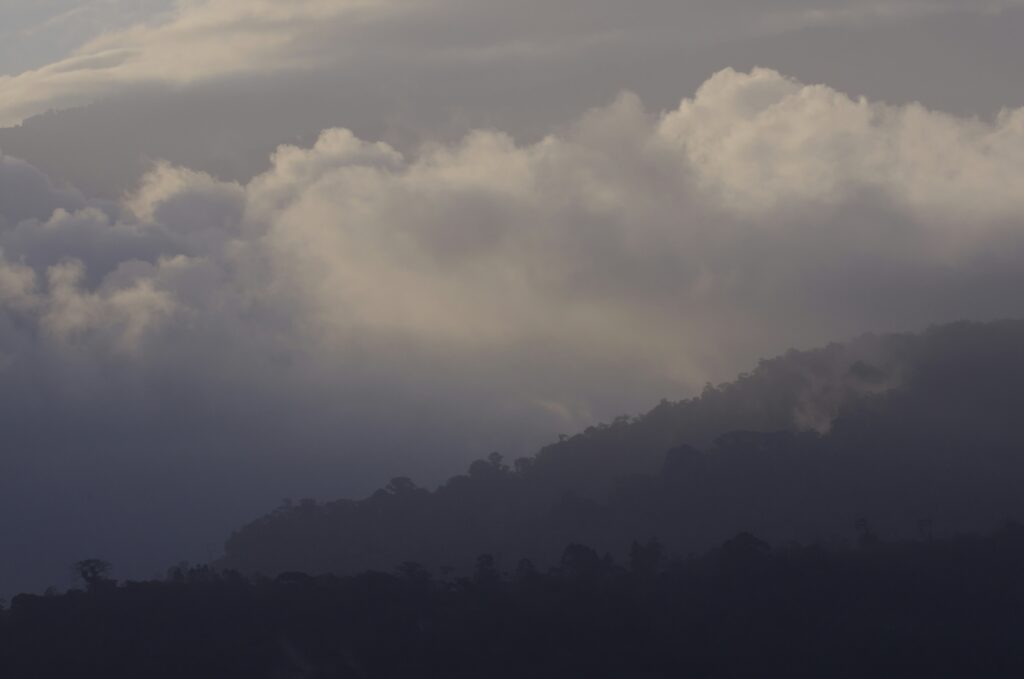 Mountain and cloud-covered volcano landscape in Costa Rica at sunset