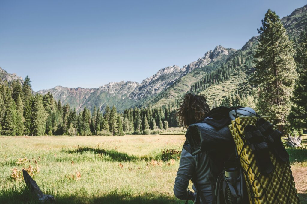 Backpacker with hiking pack for GI risk planning article