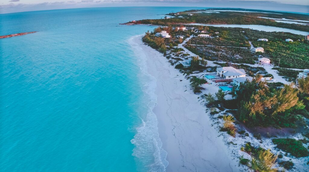 Aerial view of clear blue water and white sand beach in the Bahamas