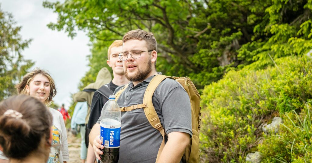 Group hikers on a trail for group travel GI outbreak planning
