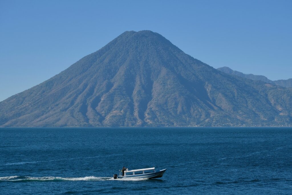 Boat on a lake with mountains in Guatemala