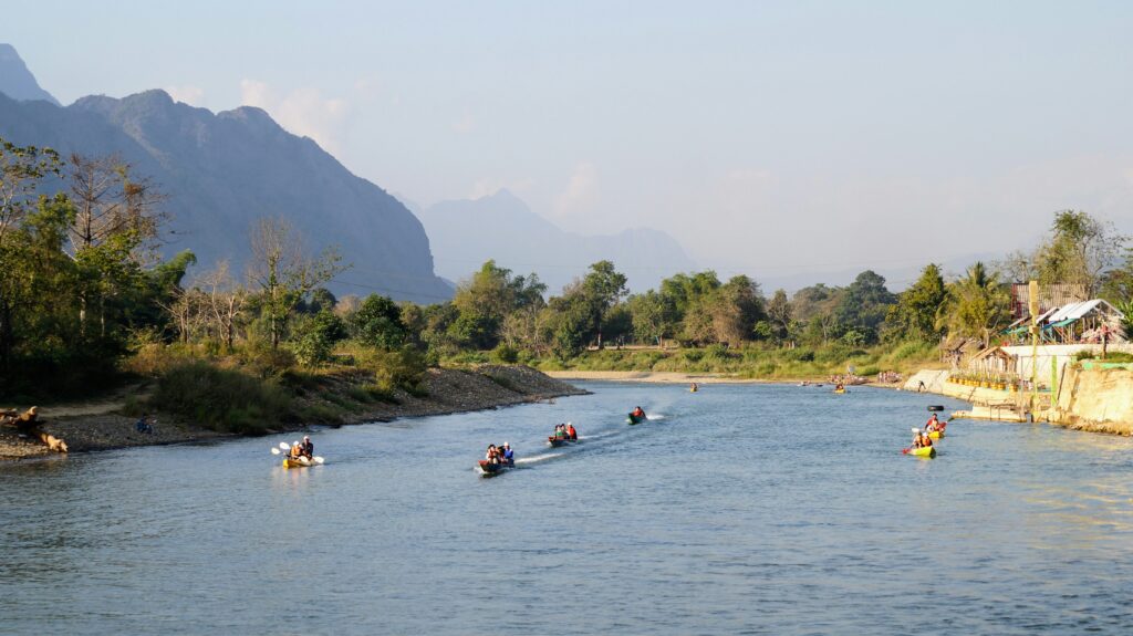 Laos travel health plan featured image showing river and mountains