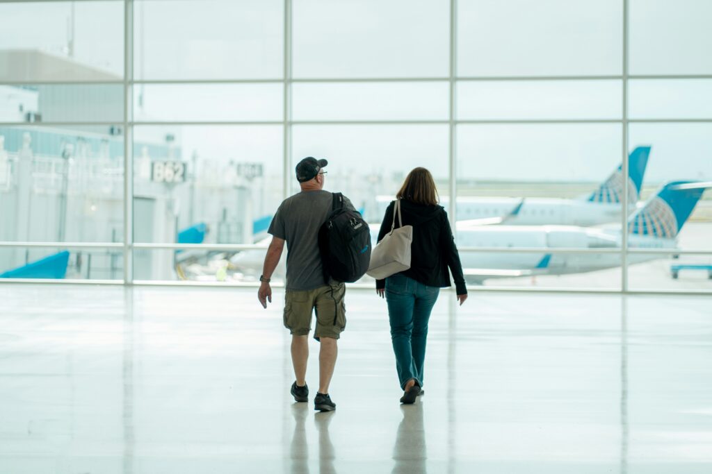 Older couple walking through an airport