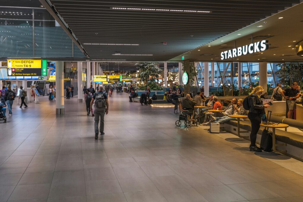 Accessible airport terminal scene with a traveler using wheelchair support.